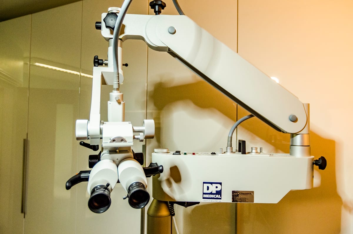 The surgical binocular microscope we use for microsuction