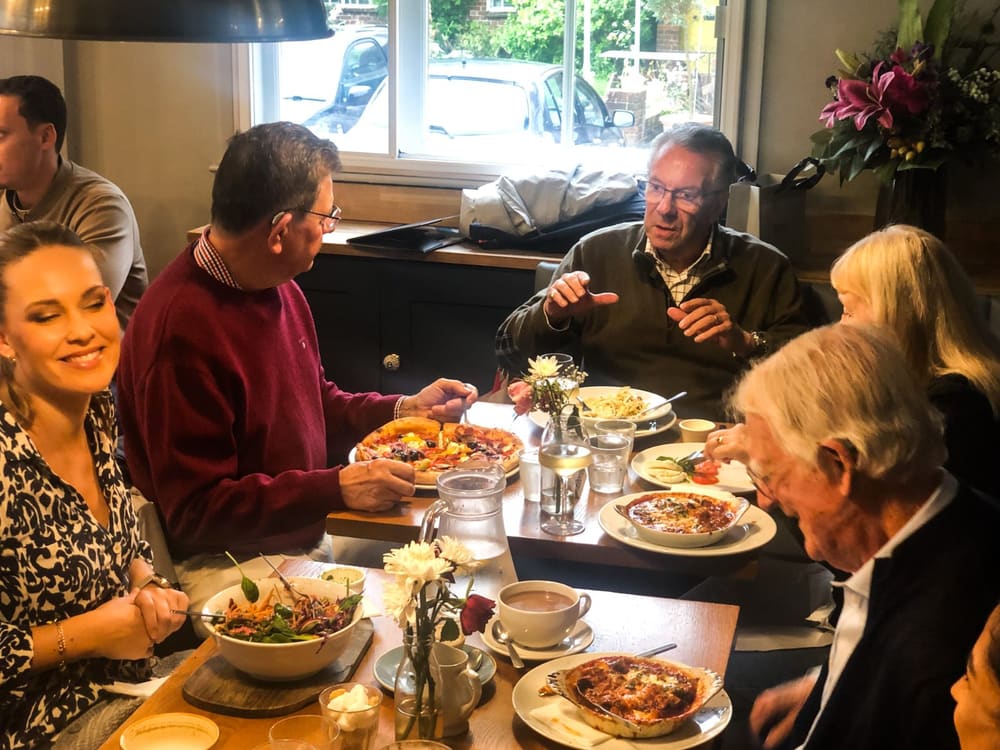 Guests in conversation around the table at a Hearology Lunch & Listen